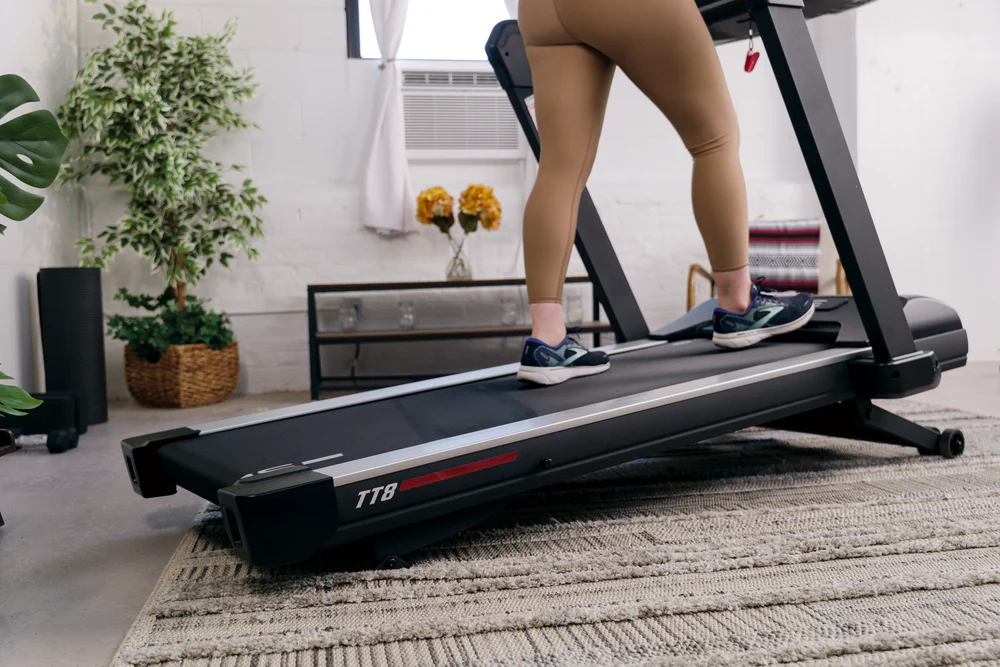 A person using the SOLE TT8 treadmill on incline.