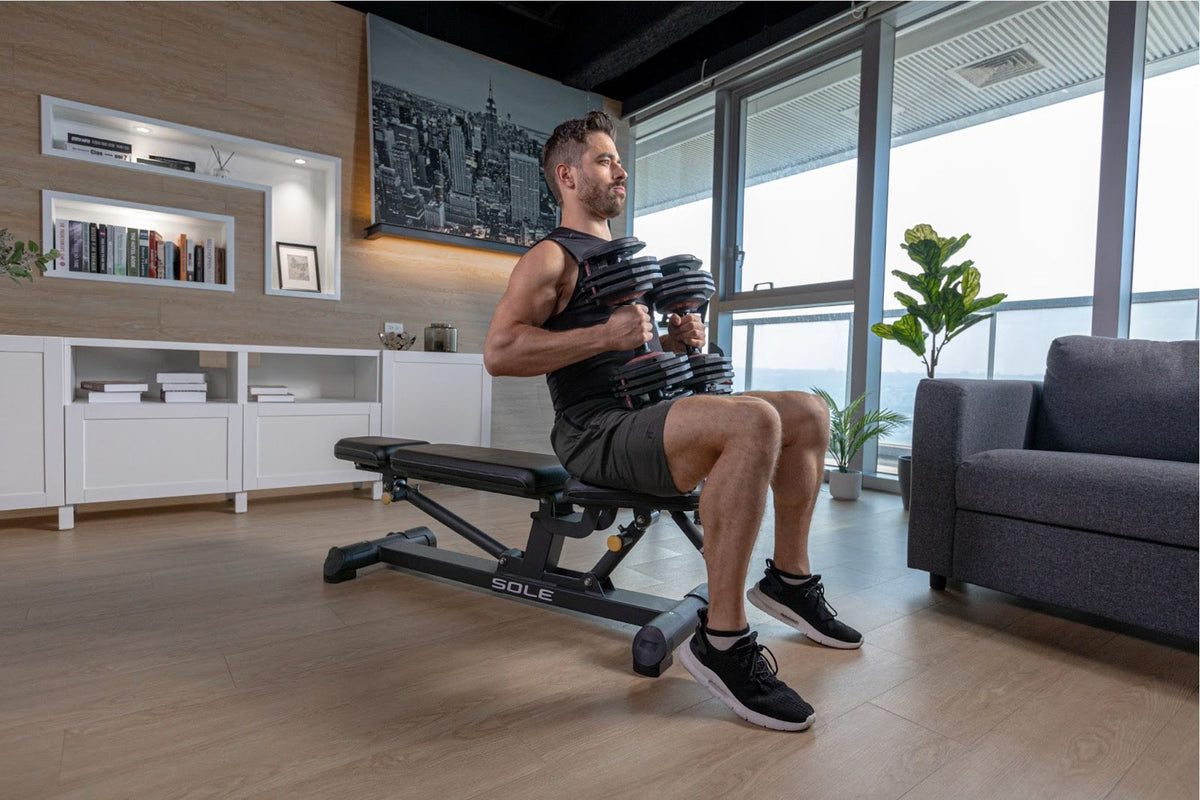 A person getting ready to start strength training using SOLE Fitness weights