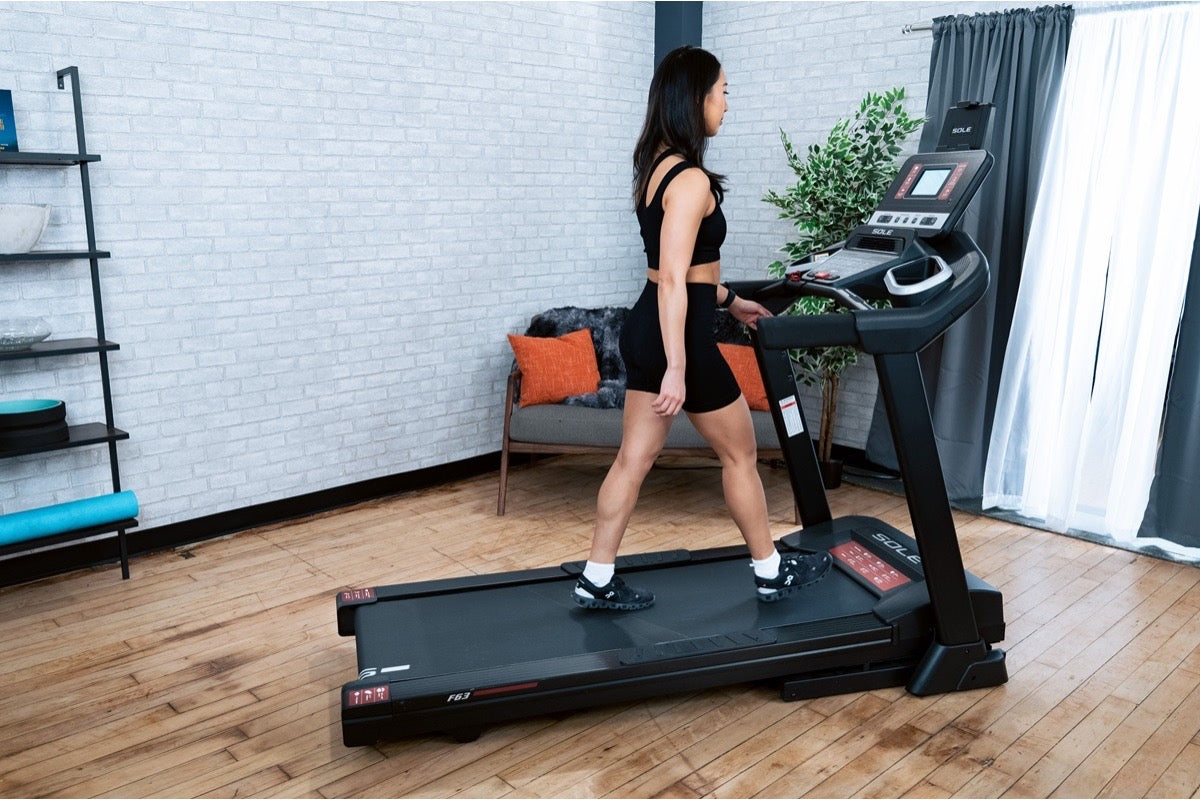 Woman walking steadily on a SOLE F63 treadmill, building toward a daily step goal