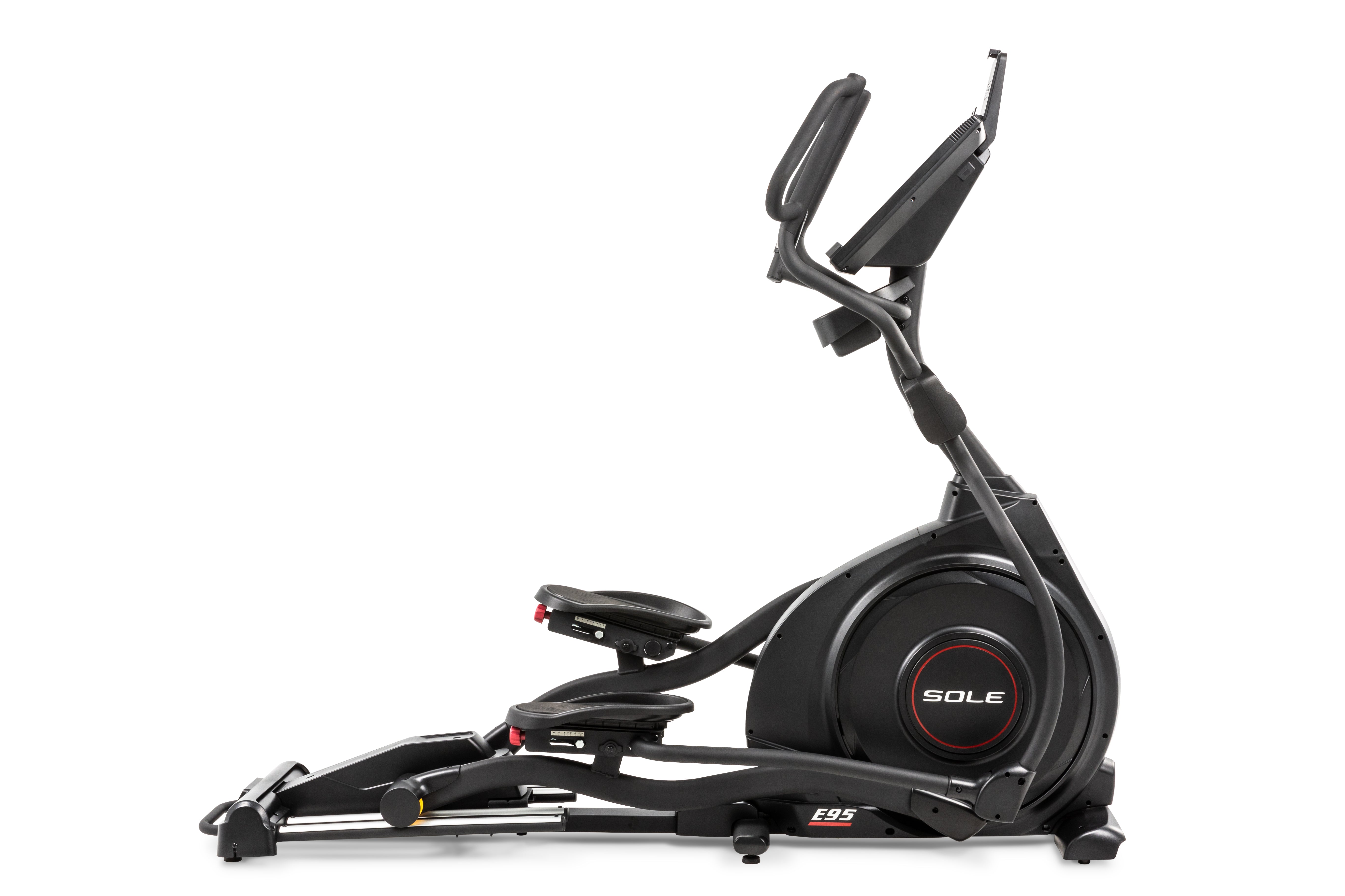 "Angled view of the Sole E95 elliptical machine, emphasizing its robust black frame. The device features a prominently displayed 'SOLE' branding on the flywheel housing, adjustable foot pedals with red adjustment dials, dual handlebars, and a streamlined console mounted at the top for displaying workout metrics.