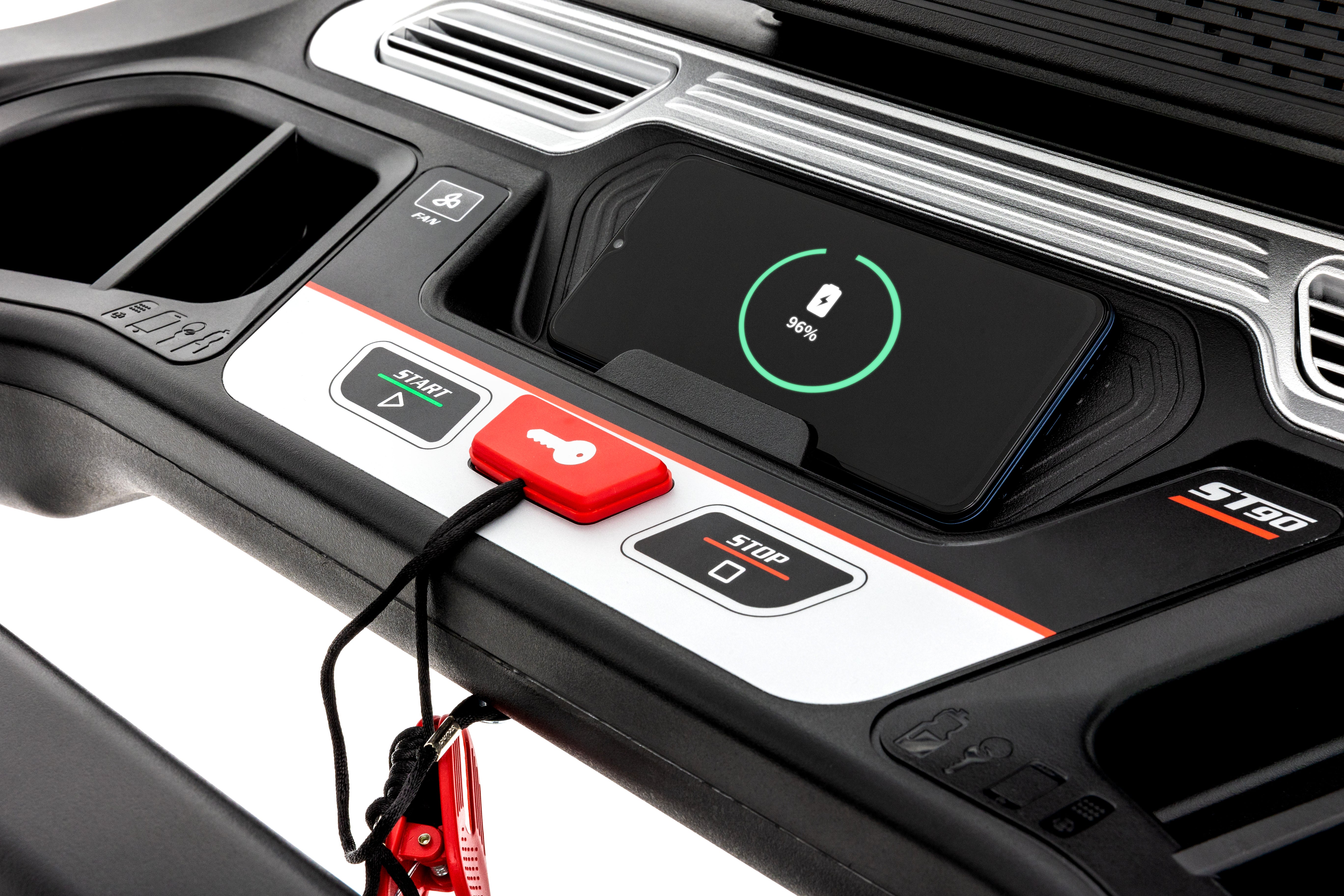 Close-up view of the Sole ST90 treadmill's central console, showing a digital display with a battery charging indicator, start and stop buttons, safety key attached with a cord, and other tactile controls against a black and silver background.