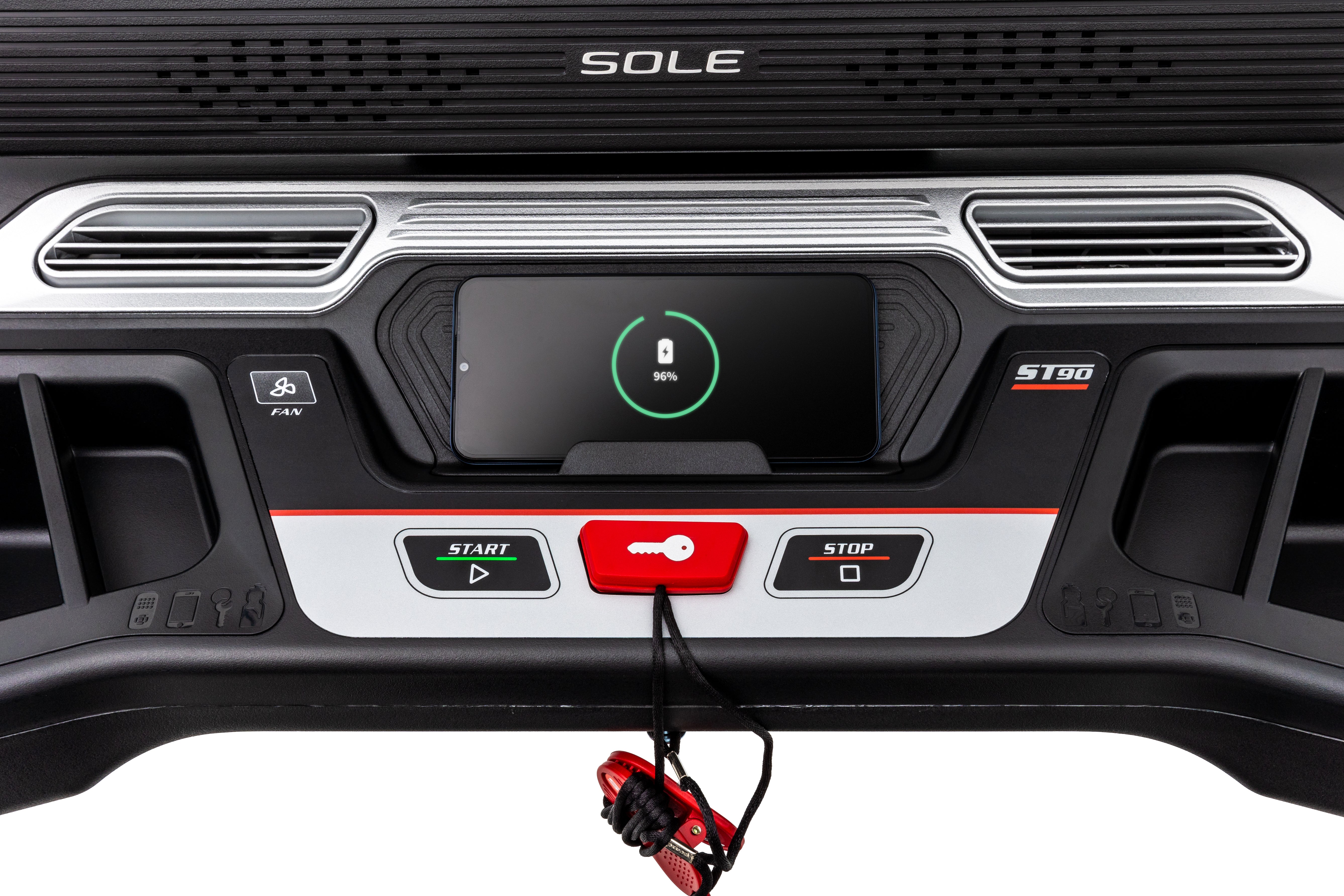 Frontal view of the Sole ST90 treadmill's control interface, highlighting the brand logo, speaker grills, start and stop buttons, and a safety key tether on its polished black and silver surface.
