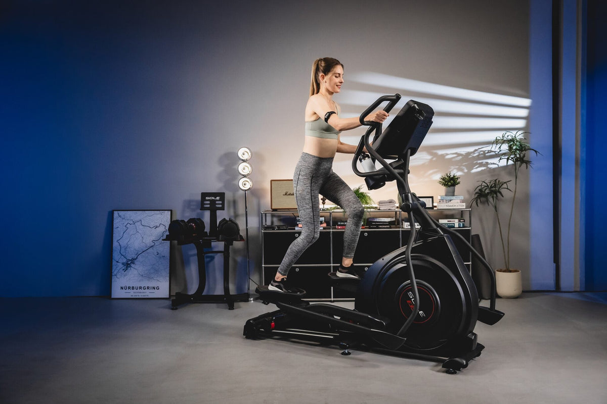 A fitness enthusiast exercising on a SOLE Fitness E35 elliptical