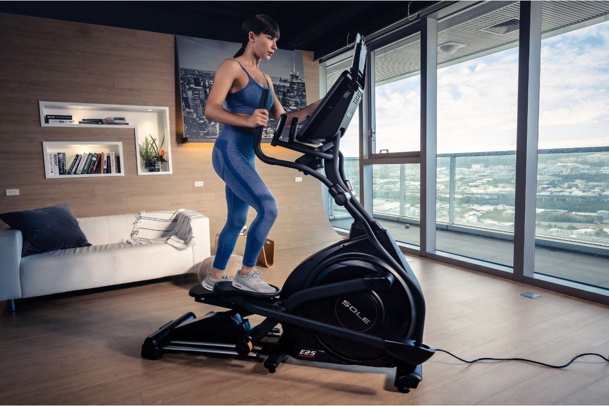 A fitness model using an elliptical, showing how it engages the core and other parts of the body