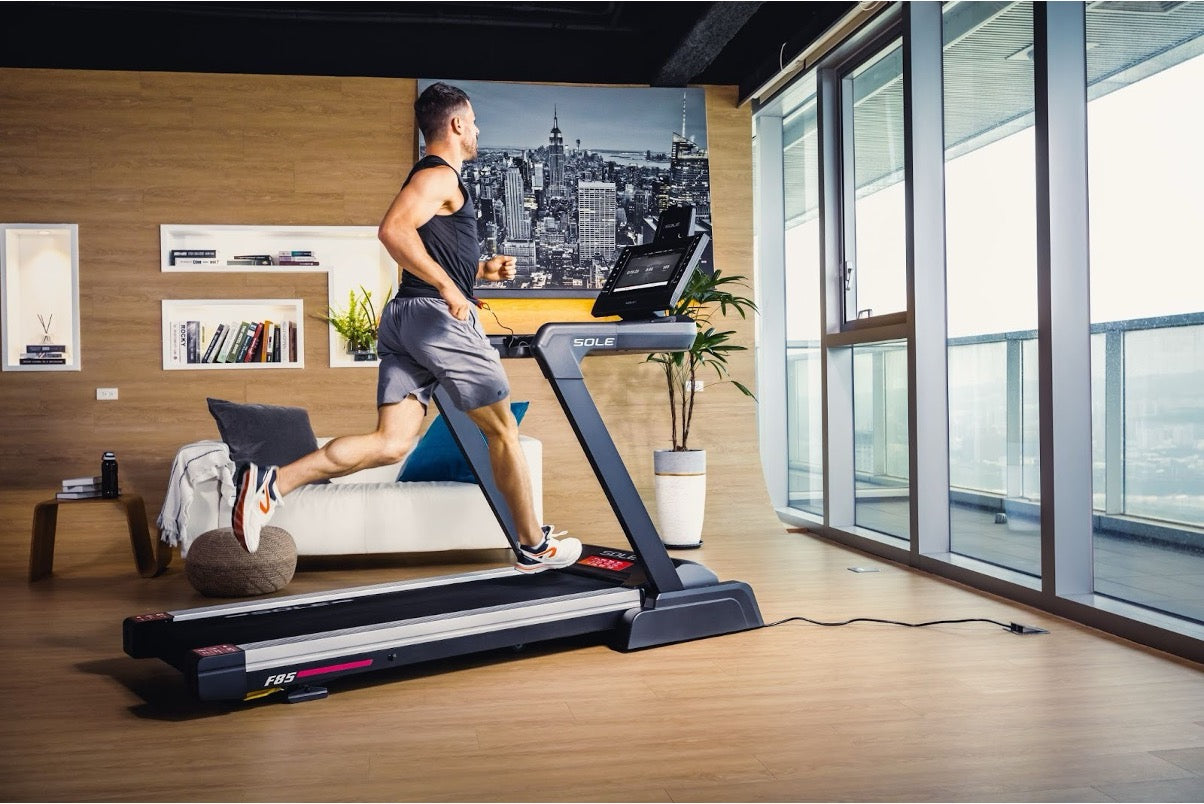 Man running on a SOLE F85 treadmill.