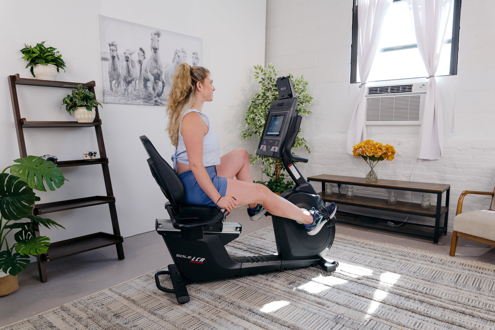 A rider using a SOLE LCR recumbent bike for a structured indoor session
