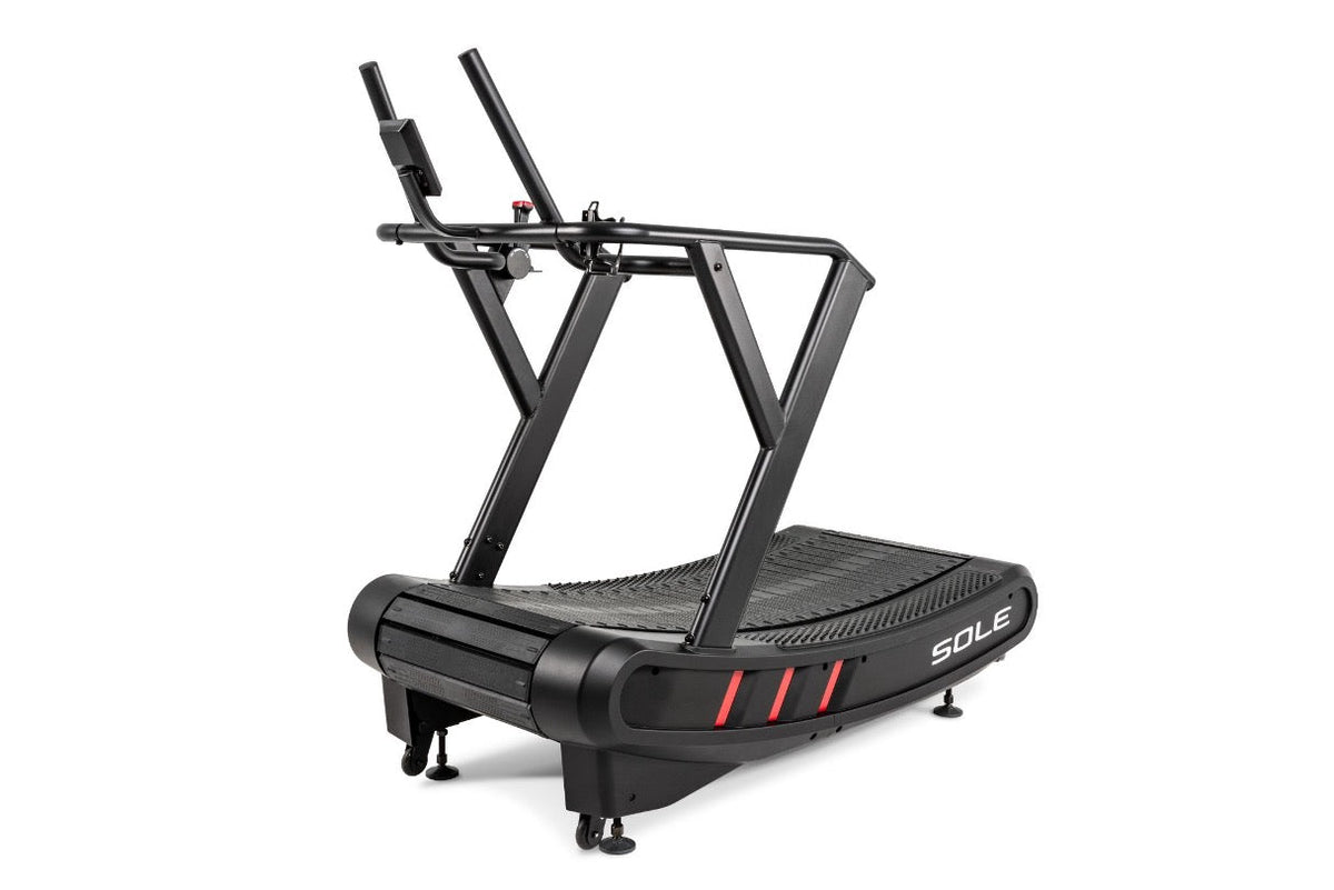 A SOLE curved manual treadmill showing dual handrails and a console mount