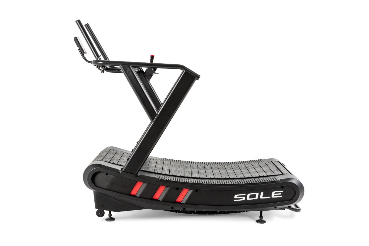 Side profile of the SOLE C80 curved manual treadmill in black, showing its concave slat belt, angled frame, and dual handrails