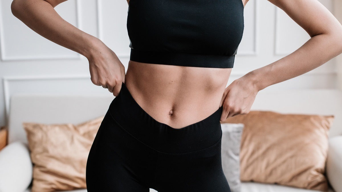 Toned midsection illustrating the visible result of overall fat loss