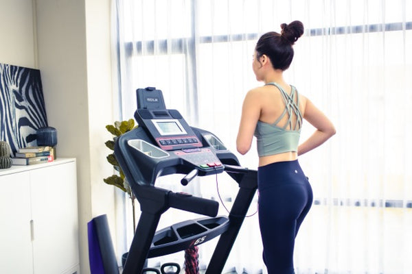 a woman standing on a treadmill