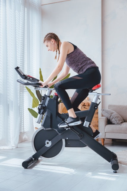 Exercise machine, Wheel, Couch, Knee, Indoor cycling, Automotive design, Rolling, Balance, Human leg, Thigh