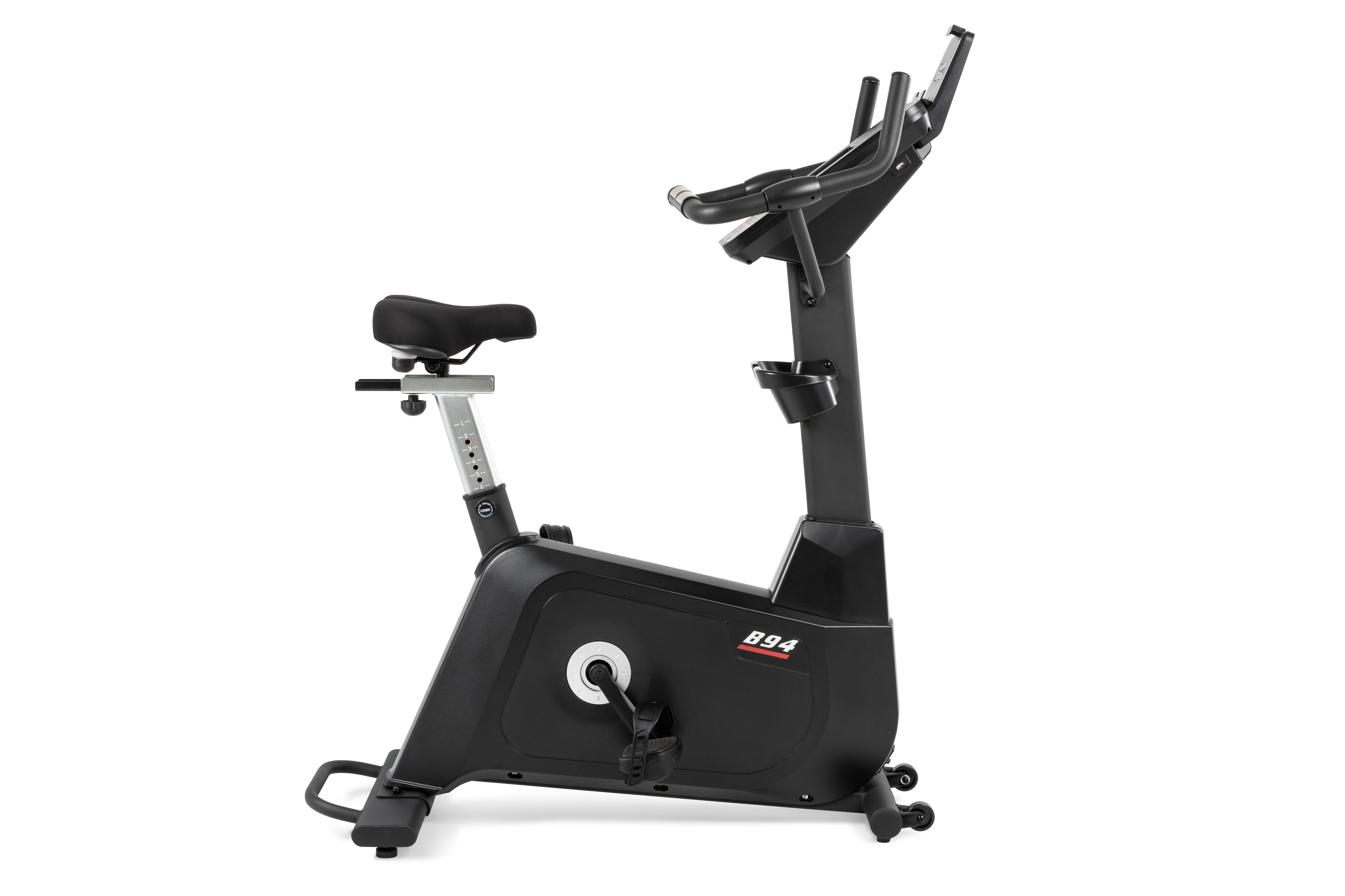 Sole B94 upright exercise bike viewed from the side, highlighting its adjustable seat and sleek black design.