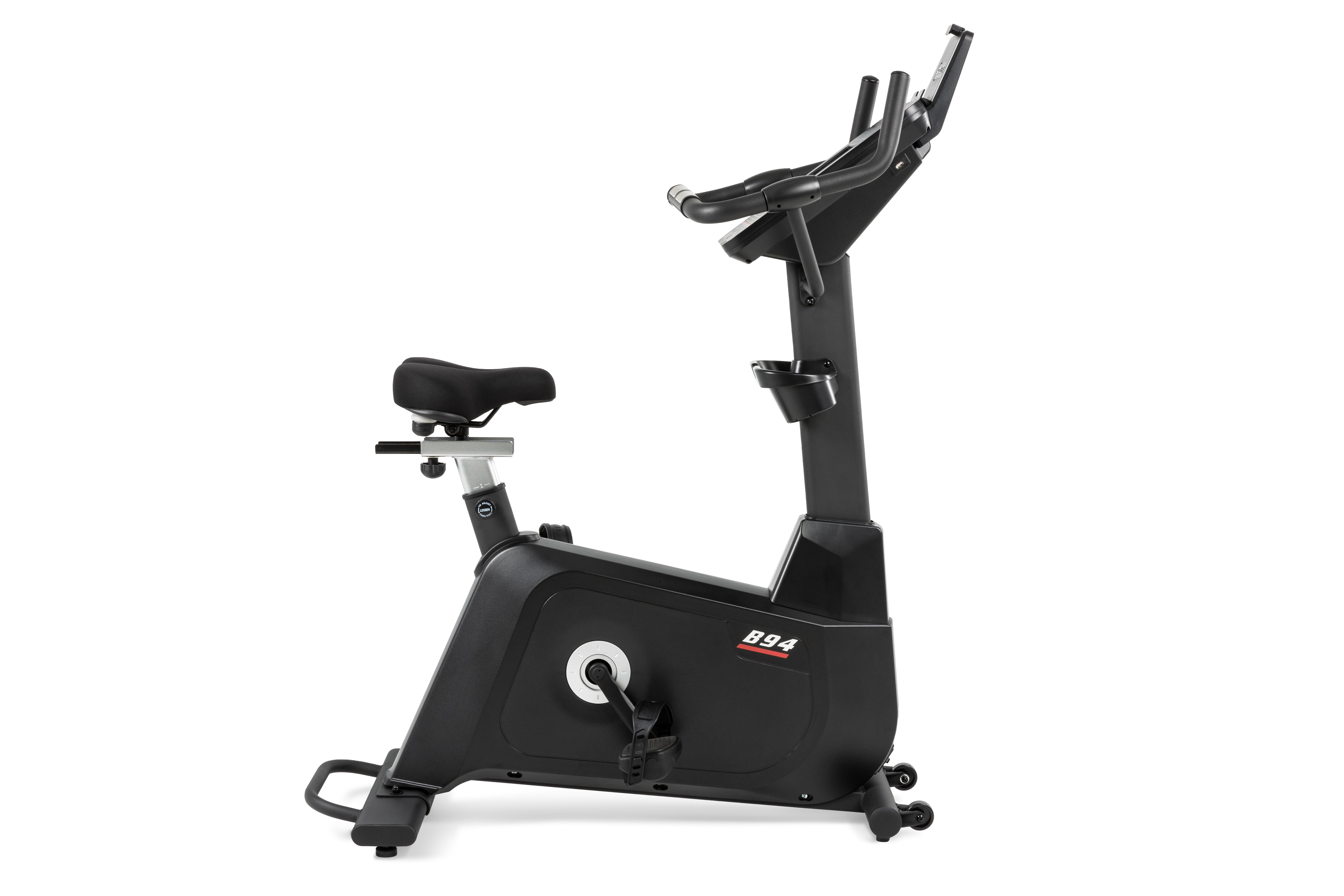 Sole B94 upright exercise bike viewed from the side, highlighting its adjustable seat and sleek black design.