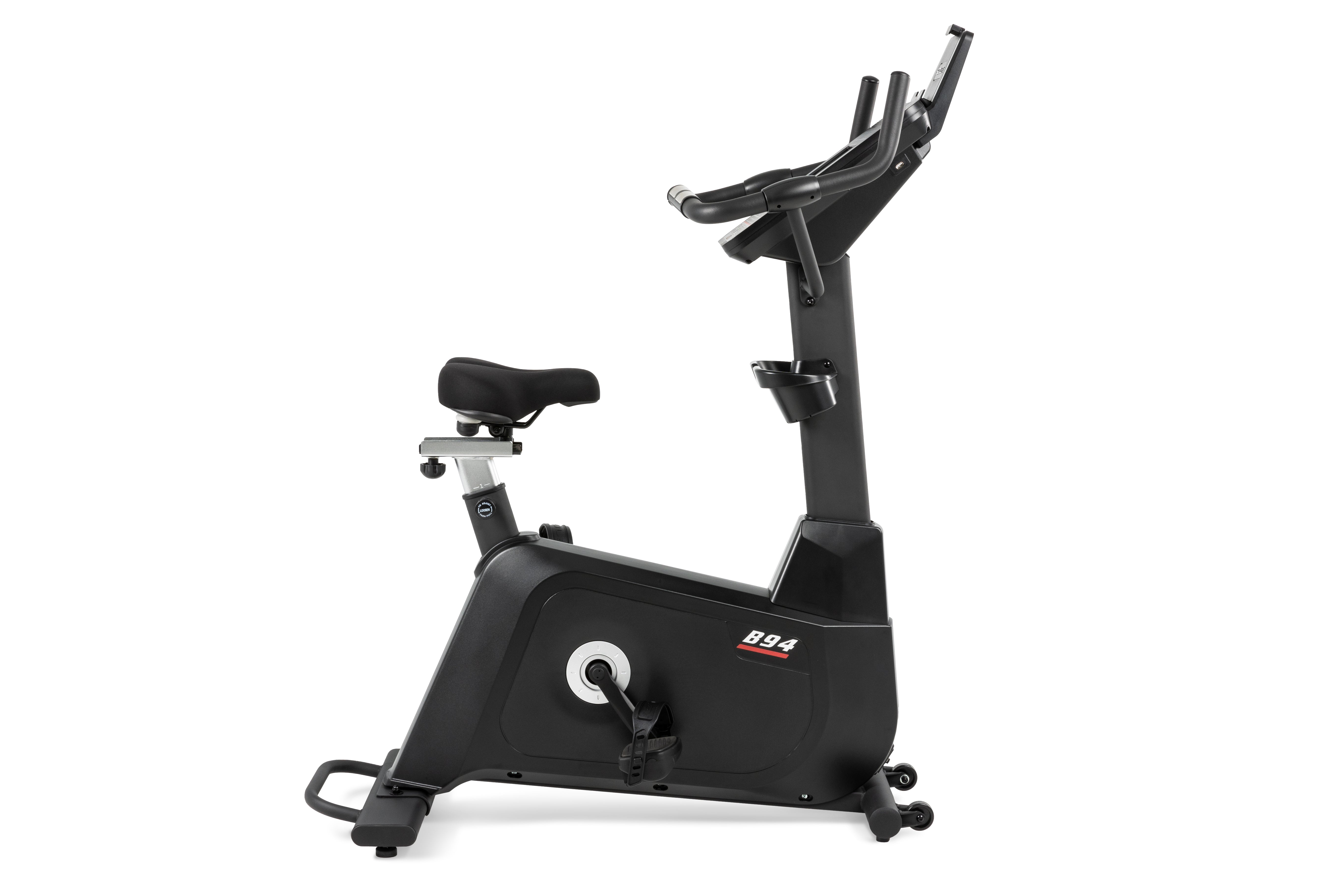 Sole B94 upright exercise bike viewed from the side, highlighting its adjustable seat and sleek black design.