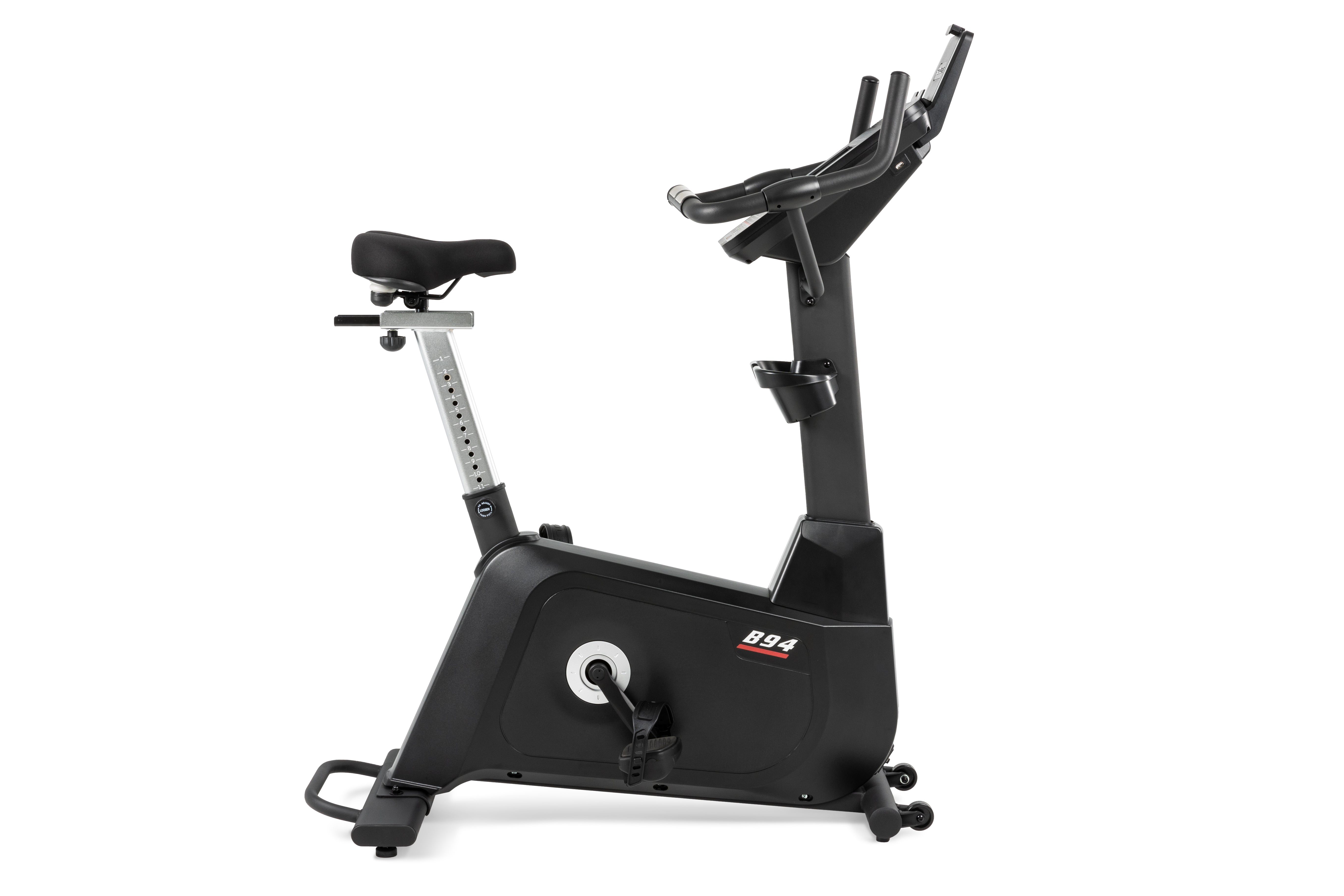 Sole B94 upright exercise bike viewed from the side, highlighting its adjustable seat and sleek black design.