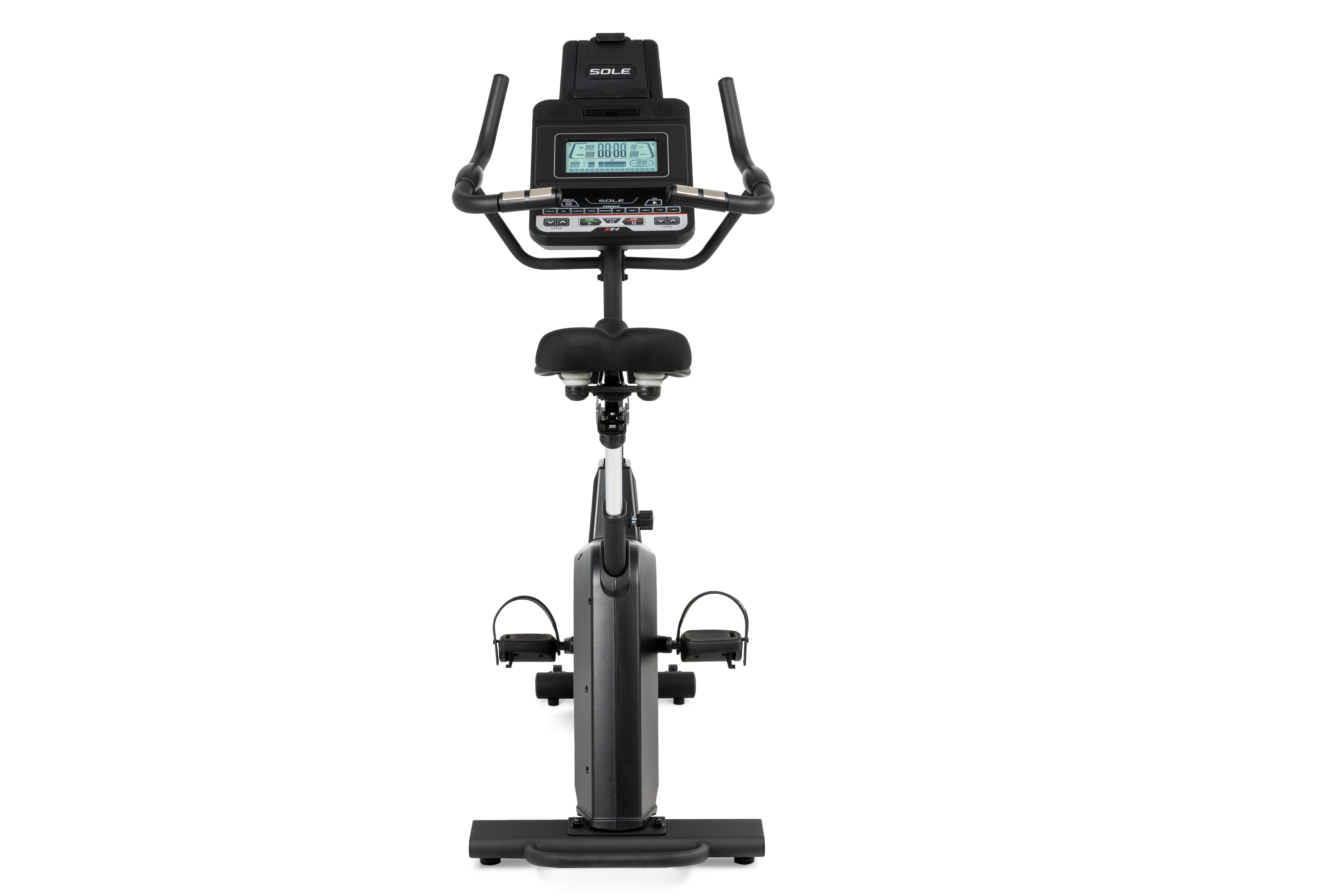 Front view of the Sole B94 stationary bike showcasing its digital console displaying workout metrics, ergonomic handlebars, adjustable padded seat, and sleek gray body with foot pedals.