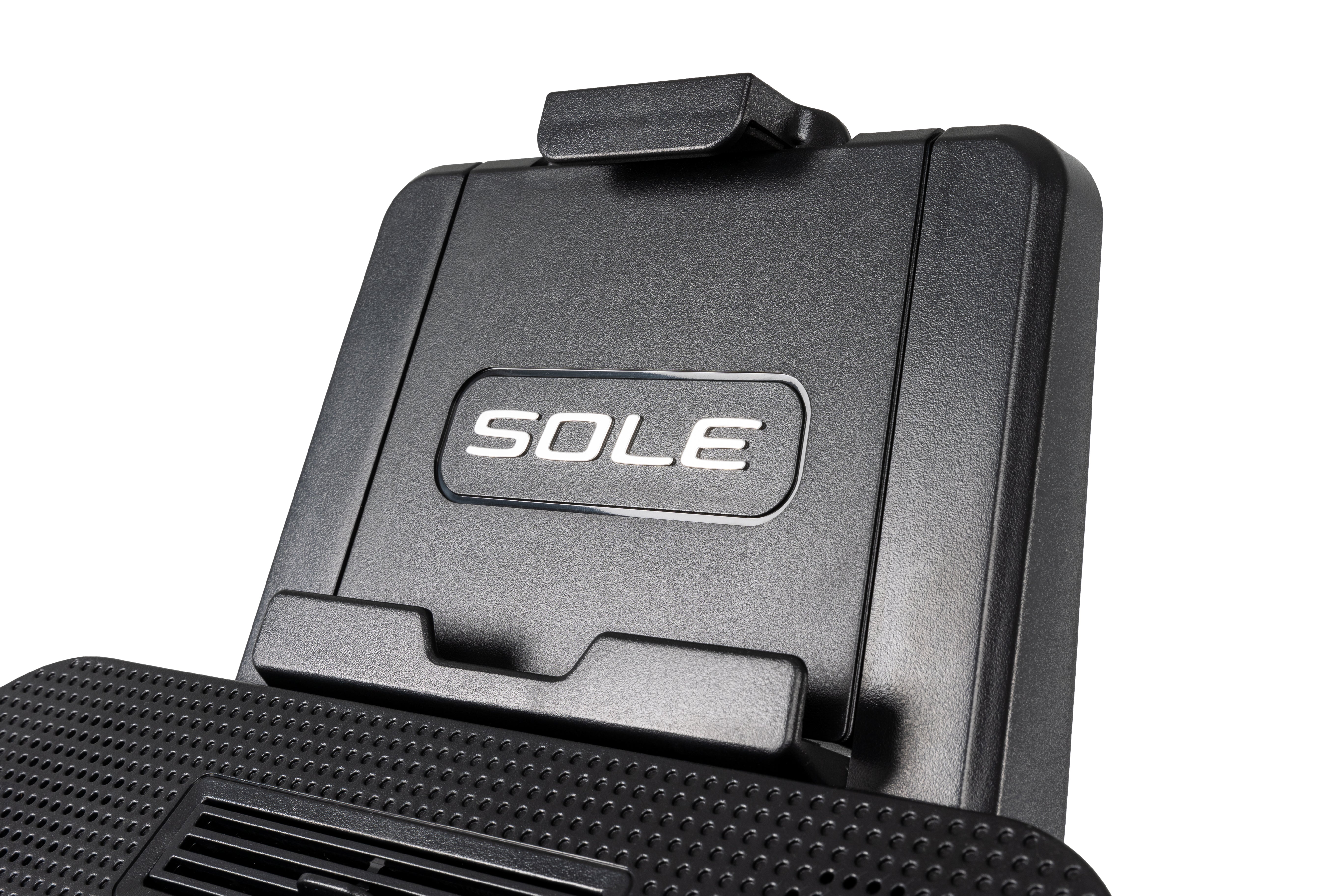 Detail view of the Sole B94's top section, highlighting the tablet holder embossed 'SOLE' logo on a textured dark surface, with an adjacent ventilation grate.