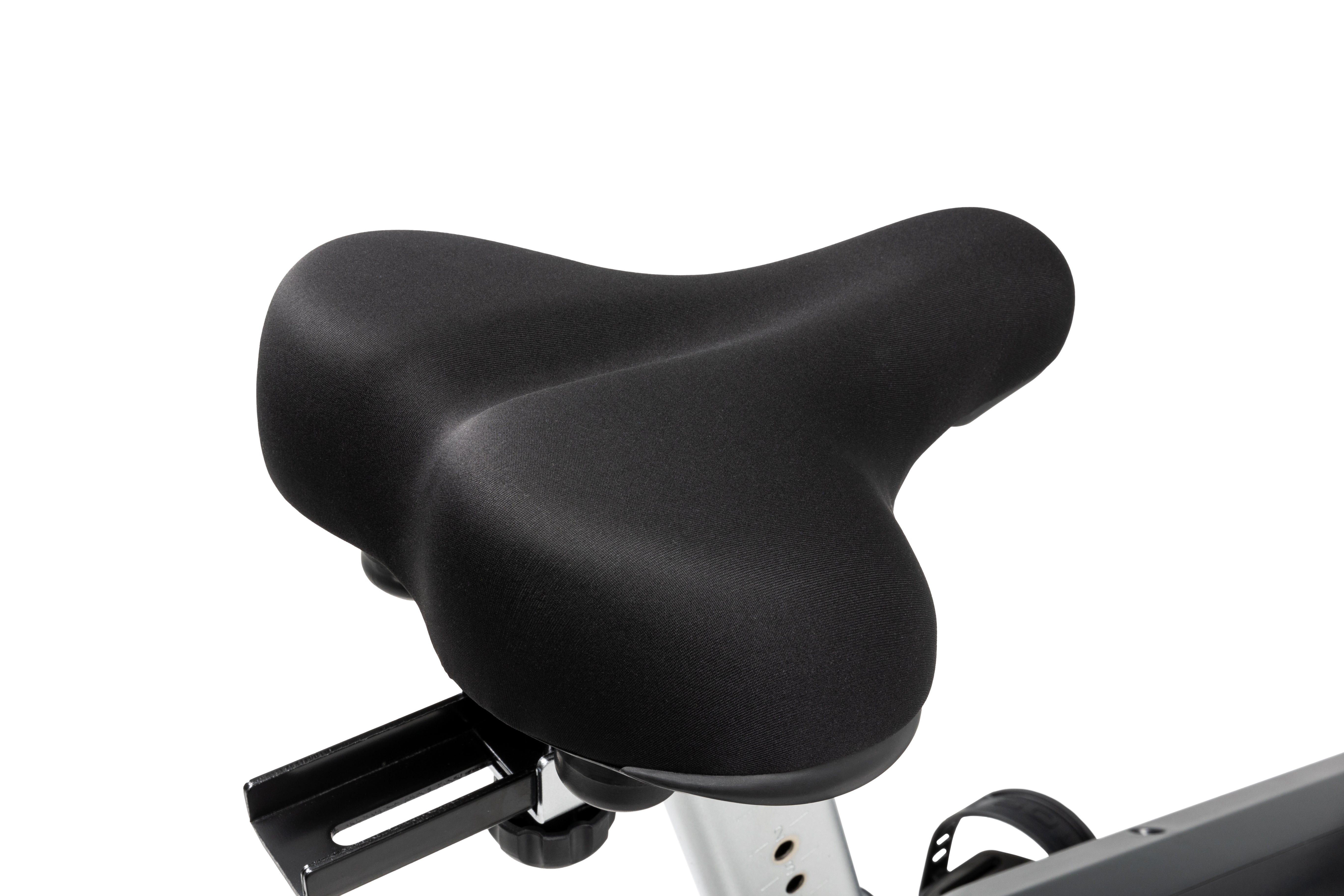 Close-up of the Sole B94 exercise bike's black cushioned seat, highlighting its ergonomic design and the attached adjustable rail.