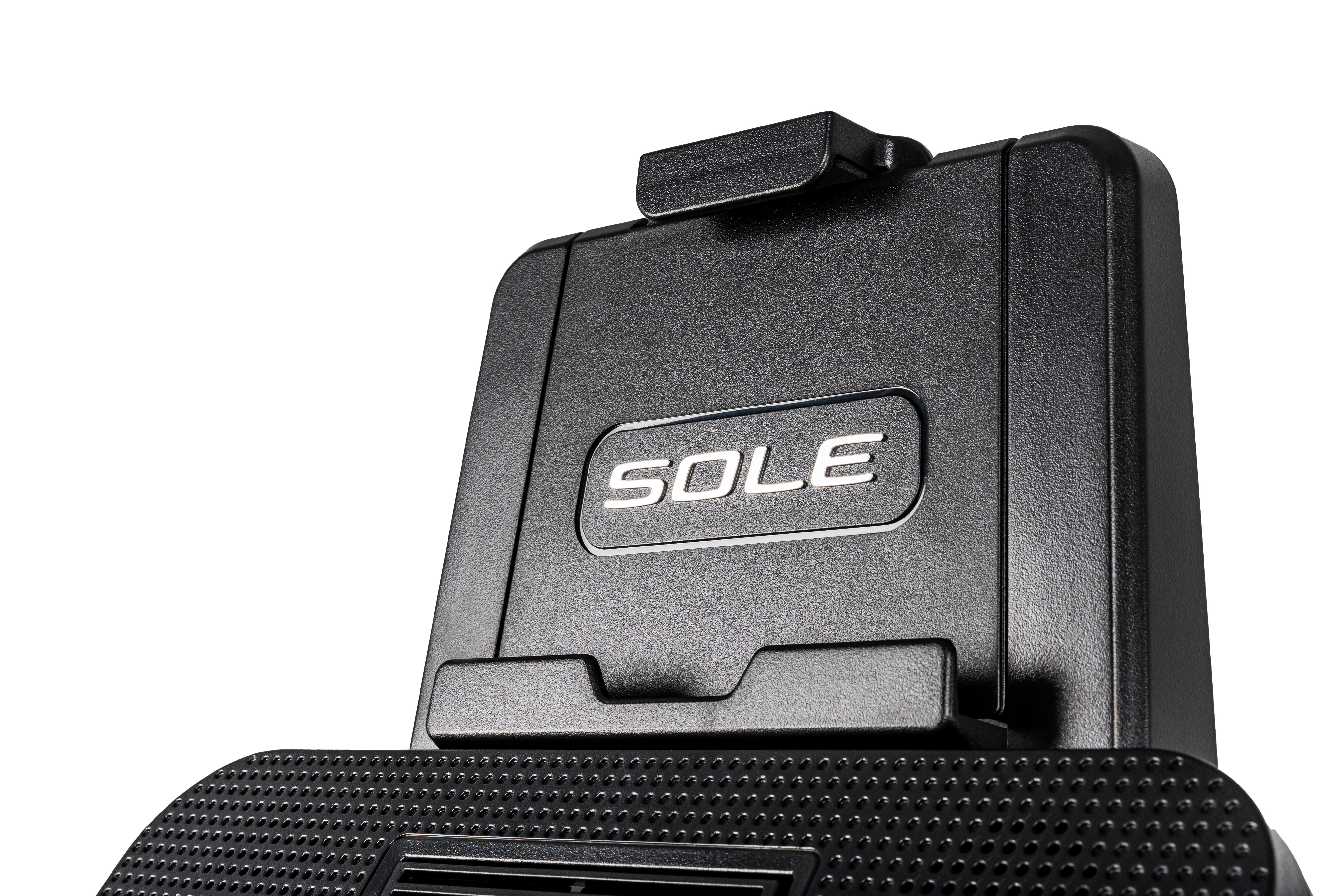 Close-up view of the top portion of the Sole E25 elliptical trainer, showcasing its textured footpad and embossed 'SOLE' logo on a sleek black surface."