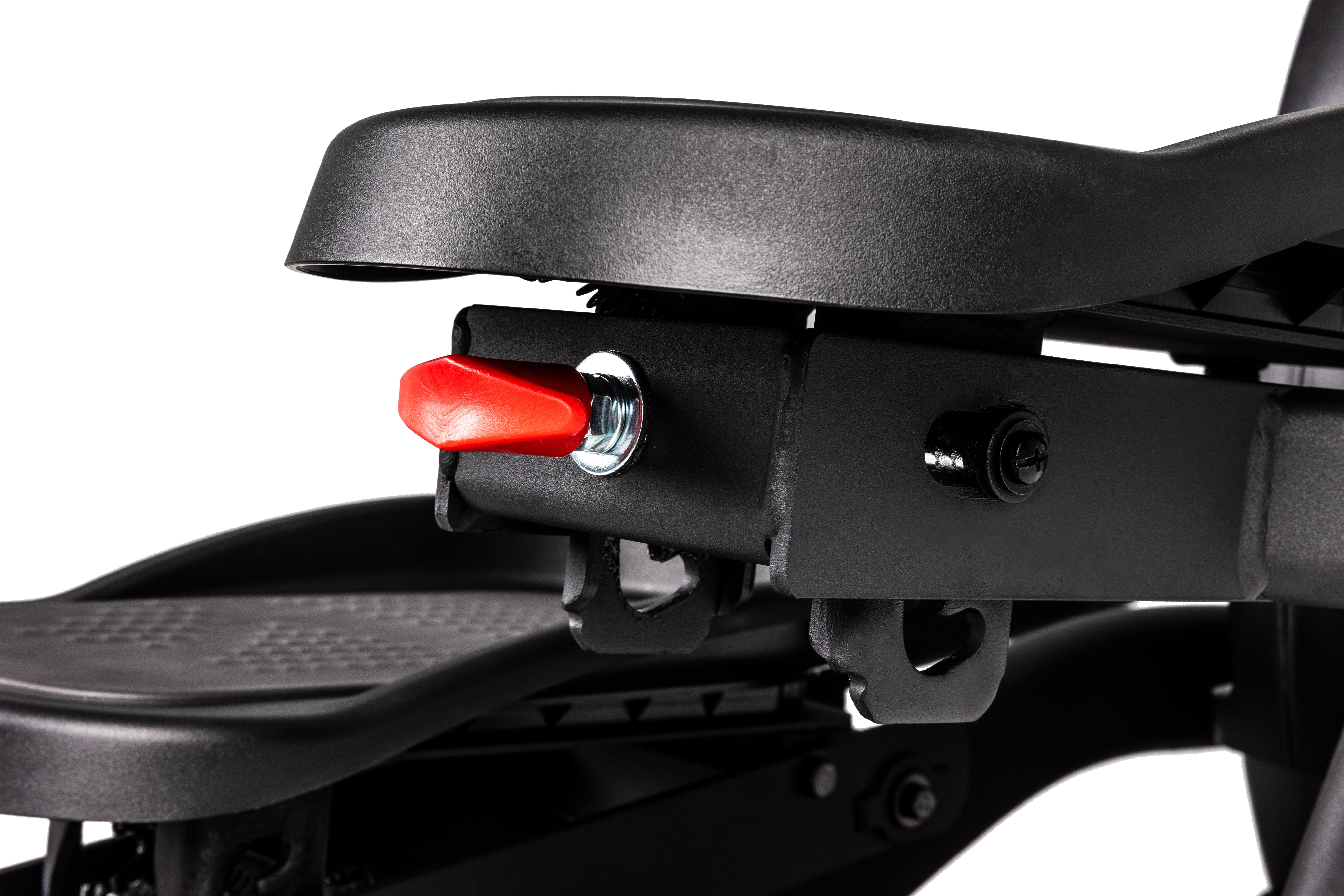 Detailed view of the Sole E35 elliptical trainer's pedal mechanism, showcasing a red adjustment knob, spring, and various bolts.