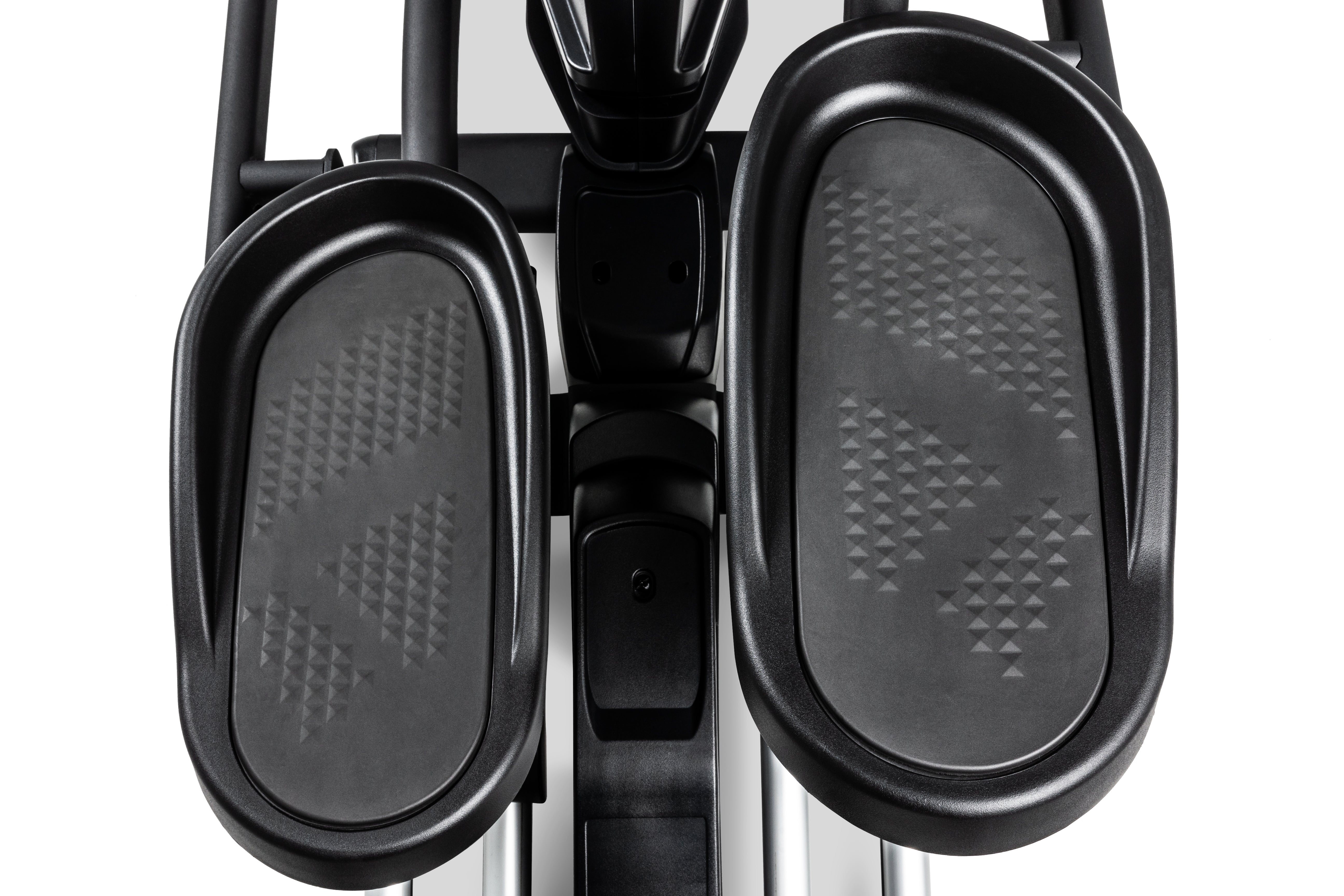 Top-down view of the Sole E35 elliptical trainer's textured foot pedals, central column, and handle attachments.