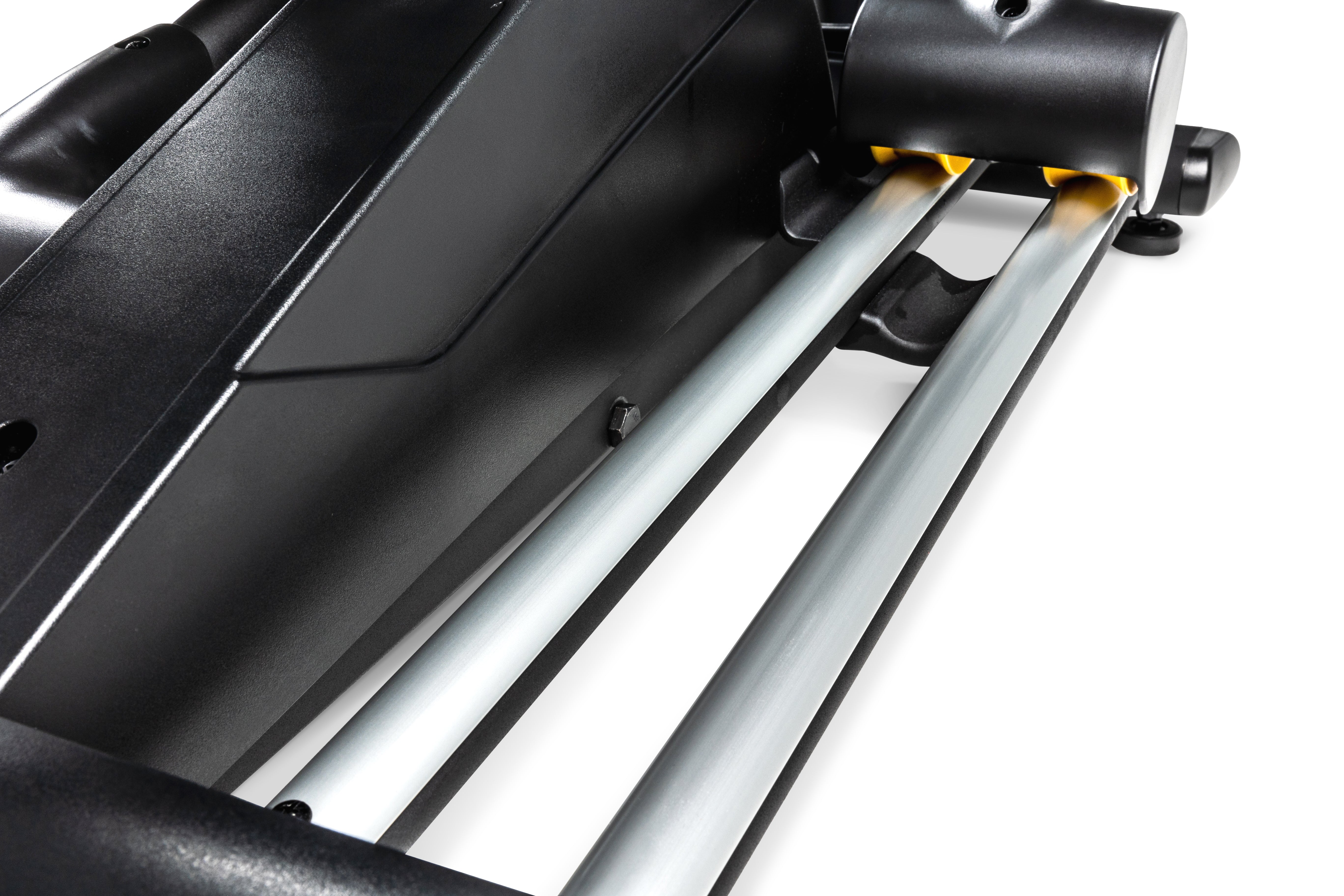 Close-up view of the Sole E35 elliptical's sleek black base and silver railings, showcasing its durable build and precision-engineered parts, including a hint of a yellow accent.