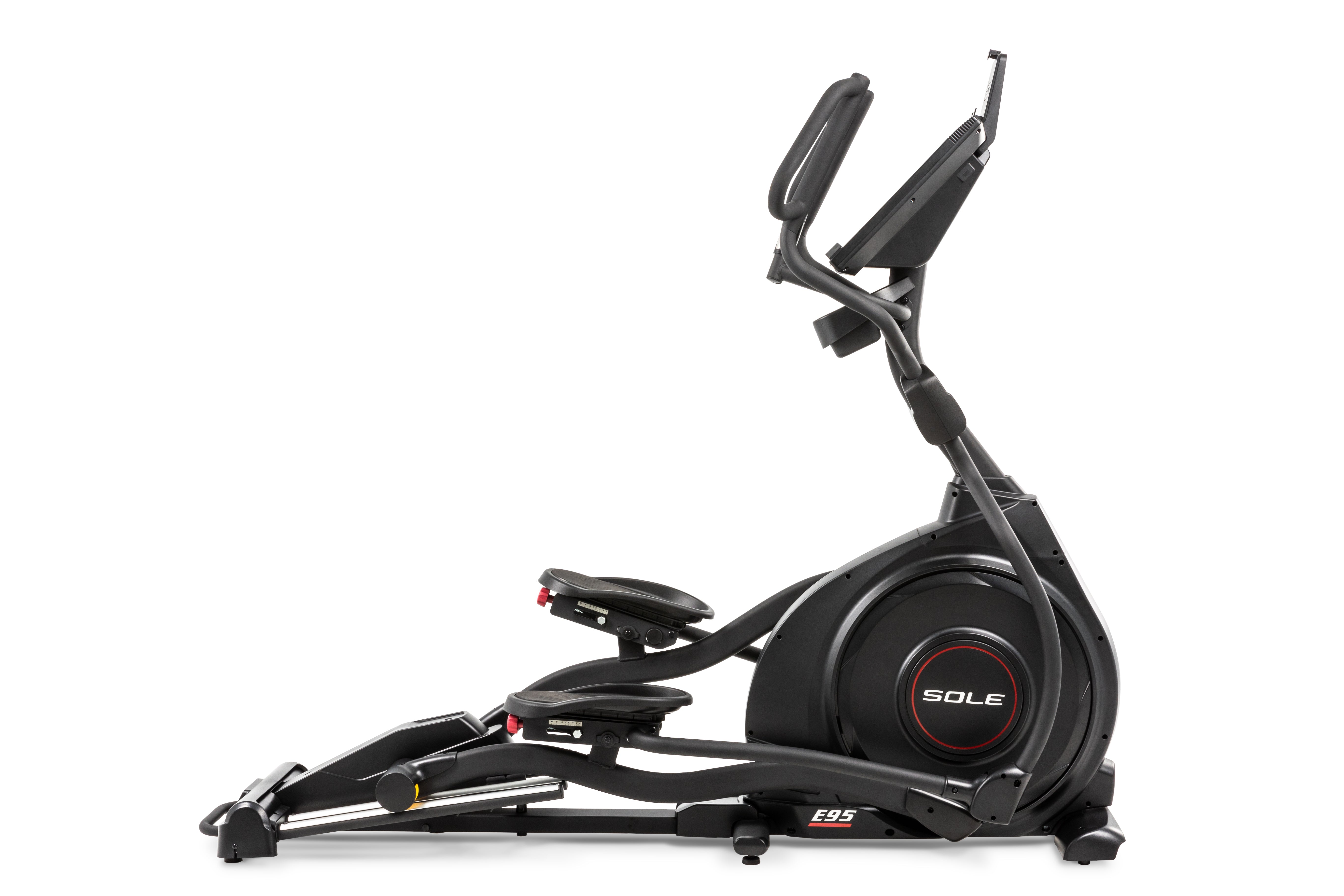 Side view of the Sole E95 elliptical machine, showcasing its sleek black design with a large flywheel housing branded 'SOLE'. The machine features adjustable foot pedals with red dials, dual handlebars with integrated controls, and an elevated console displaying workout metrics.