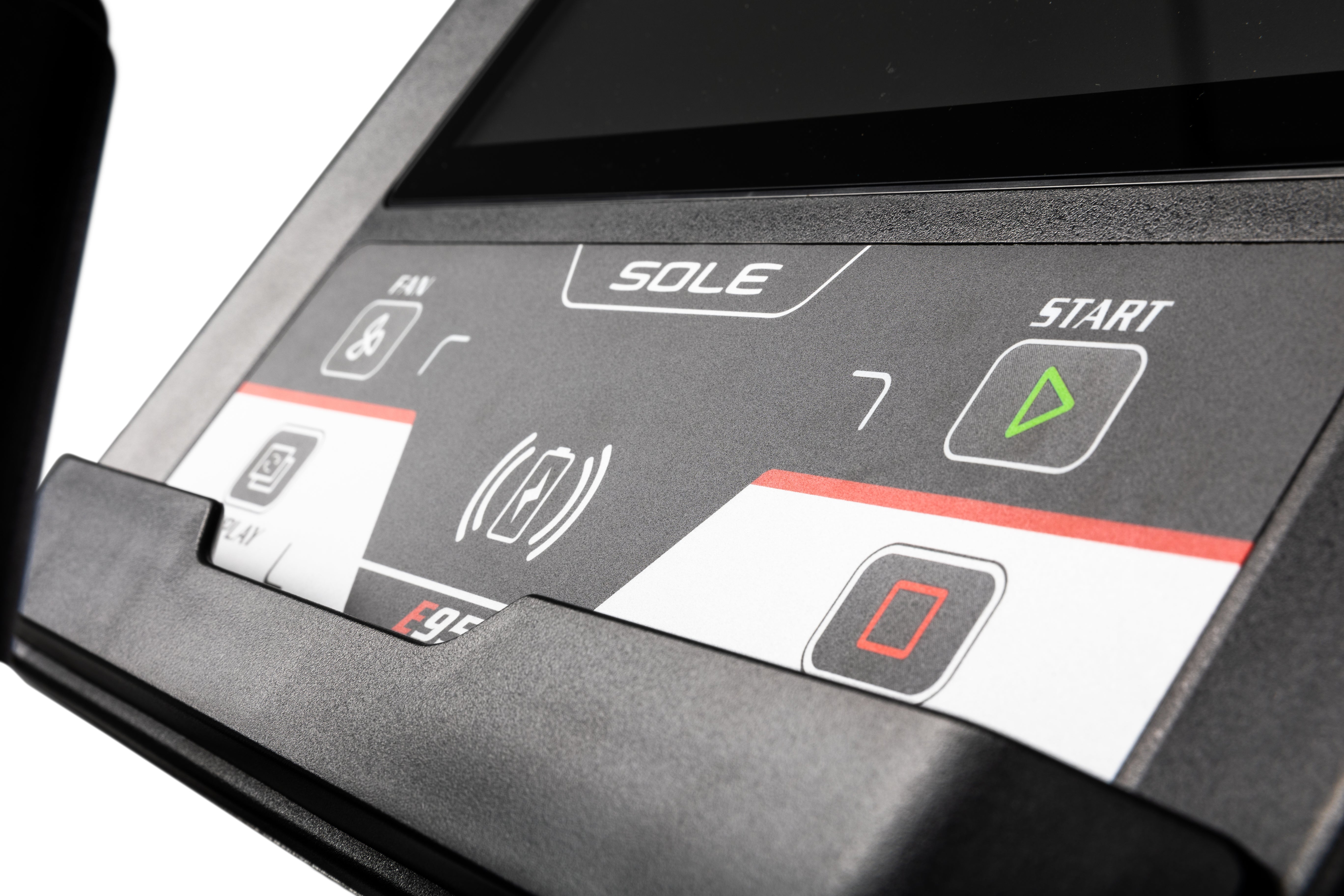 Detail shot of the Sole E95 elliptical machine's control panel, highlighting the SOLE logo, various button icons including fan and volume, and tactile buttons labeled 'START' and a stop symbol.