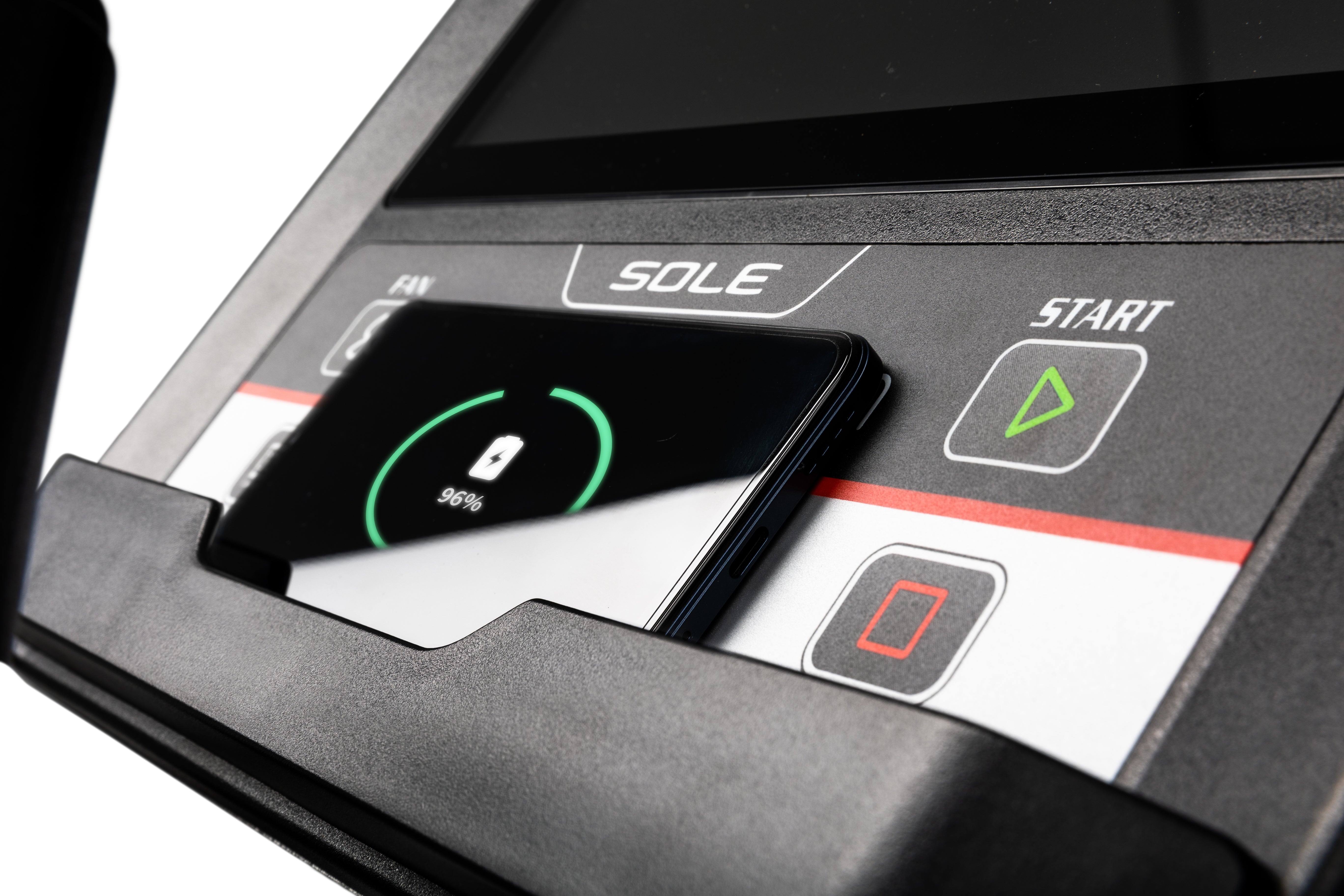 Close-up view of the Sole E95 elliptical trainer's control panel, displaying the SOLE branding, a smartphone with a charging indication of 98%, and tactile buttons labeled 'START' and a stop symbol.