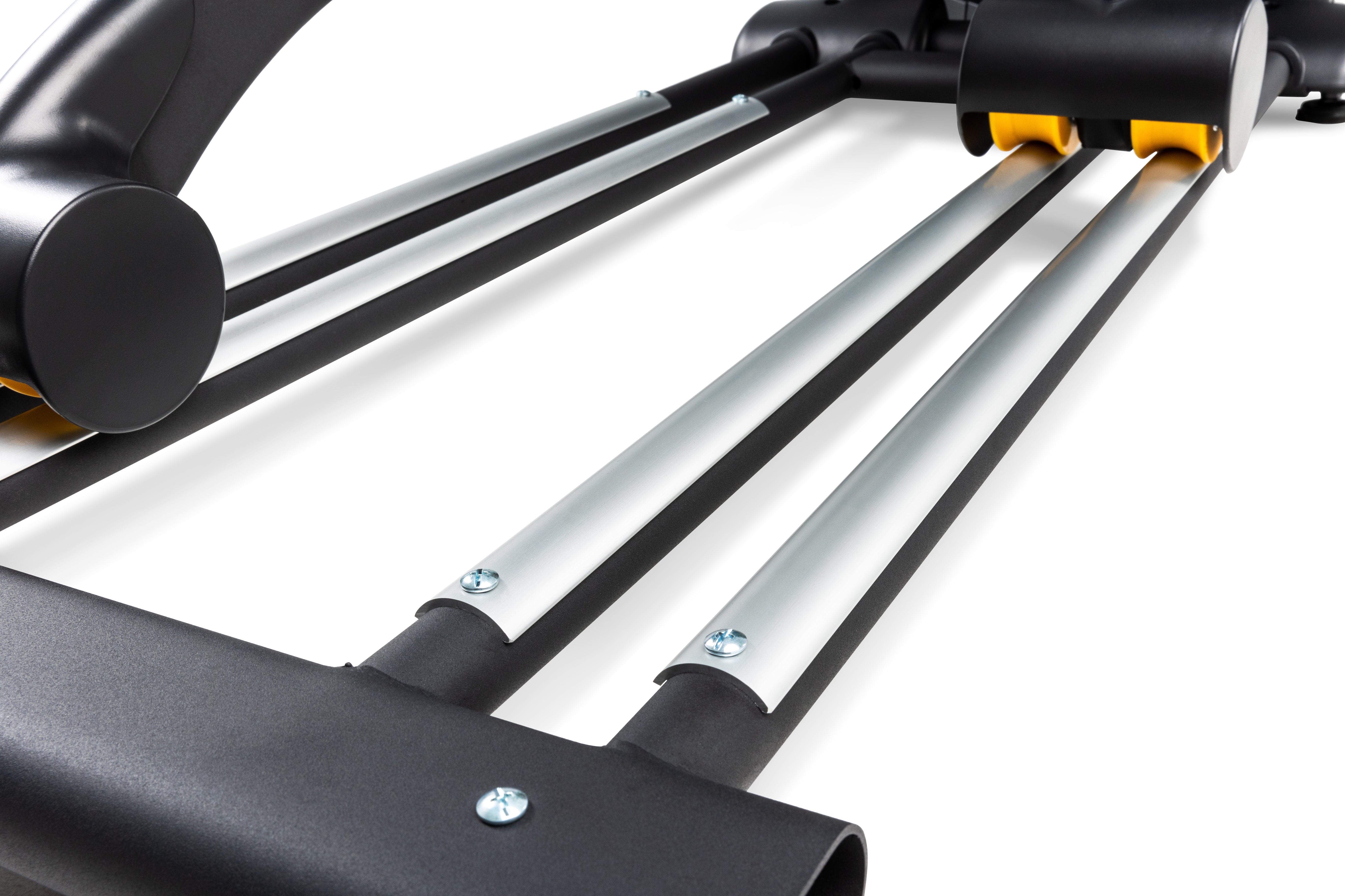 Close-up view of the Sole E95S elliptical machine's foot pedal rails, highlighting the silver tracks, black supports, and yellow rollers. The build quality is emphasized with visible screws and smooth finish.