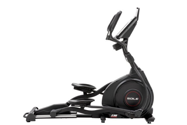 Side view of the Sole E98 elliptical trainer showcasing its digital display, foot pedals, and branding, on a white background.