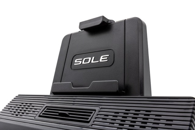 Close-up view of the black base of the Sole E98 machine, featuring the embossed "SOLE" logo and a textured footplate with a central vented area.