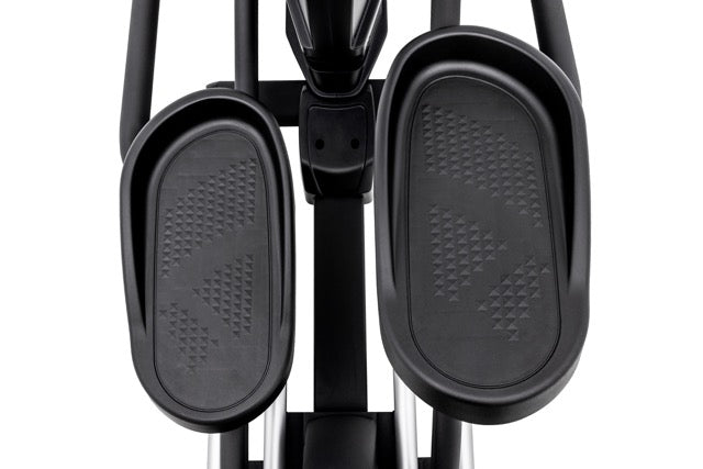 Top-down view of the Sole E98 elliptical foot pedals with textured grip patterns, showcasing the pedal's curve and surrounding frame structure.