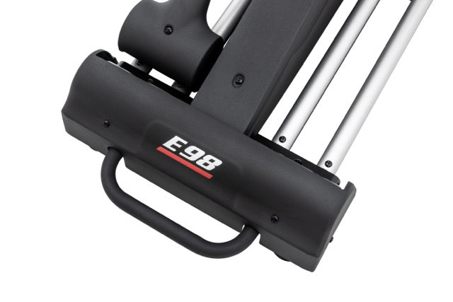 Detailed view of the Sole E98 elliptical machine's lower section, showcasing the "E98" logo, dark grey casing, white guide rails, and a curved handle against a white background.