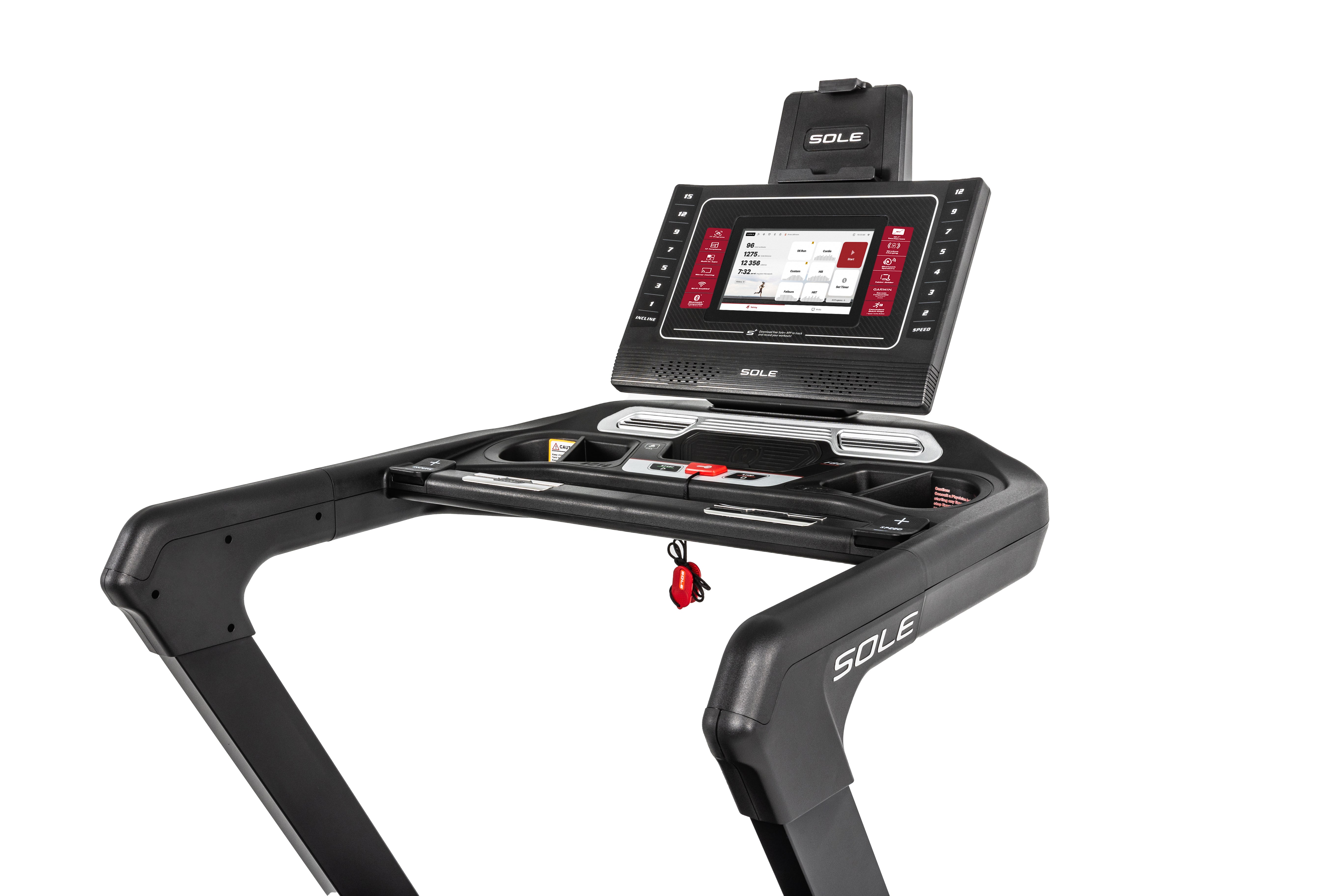 Close-up view of the Sole F80 treadmill's console area, featuring a digital touchscreen display, emergency stop key with red cord, button controls, and the "SOLE" logo on the handrails.