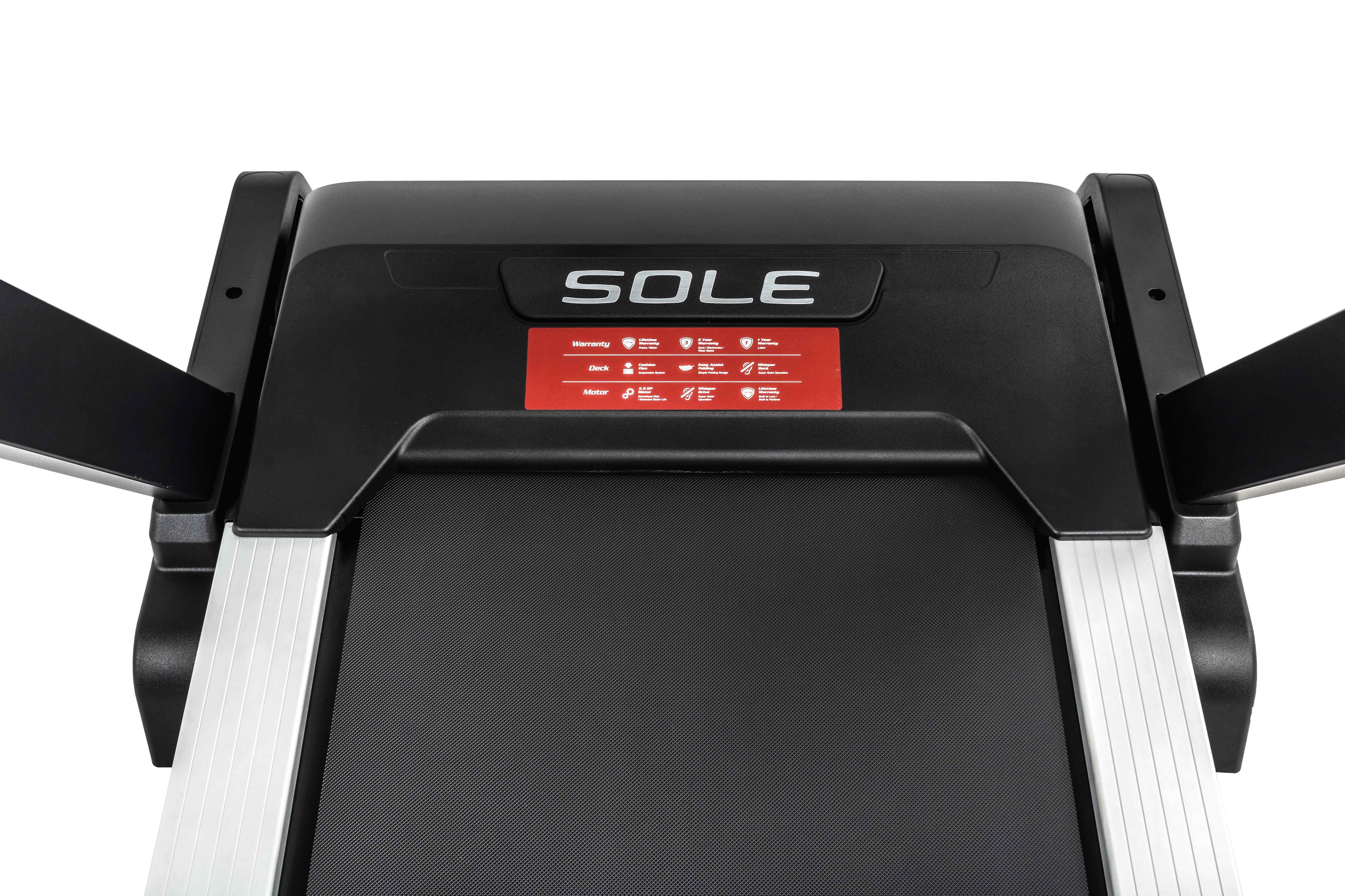 Overhead view of the Sole F80 treadmill showcasing the black running deck, side metallic rails, and a section of the control panel with the Sole logo and red warning labels.