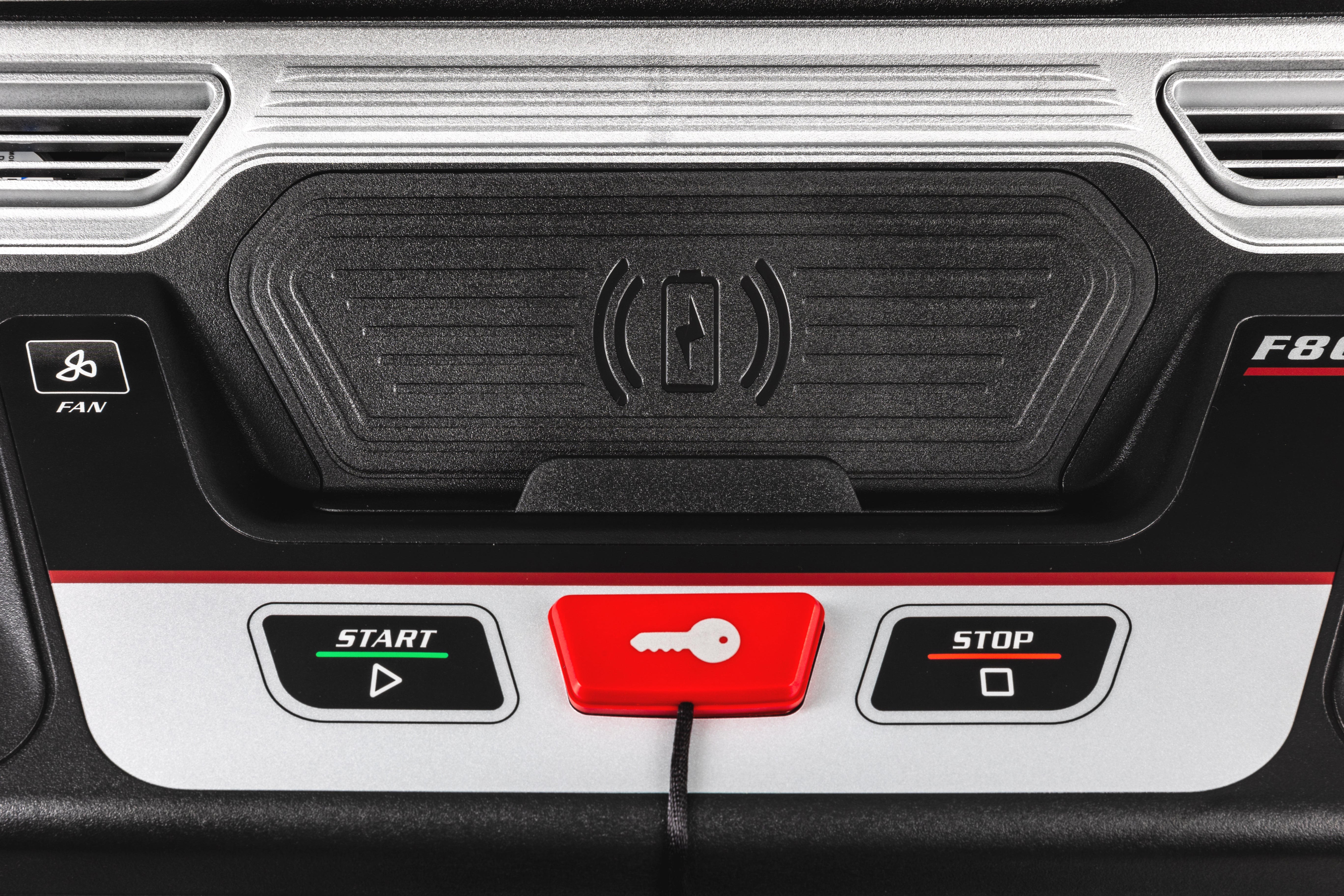 Close-up view of the control panel on the Sole F80 treadmill, showing a "FAN" button on the left, a central tactile button with up and down arrows for adjustments, and the "START" and "STOP" buttons on the right side. A red safety key is inserted next to the "START" button. The "F80" logo is visible in the top right corner.