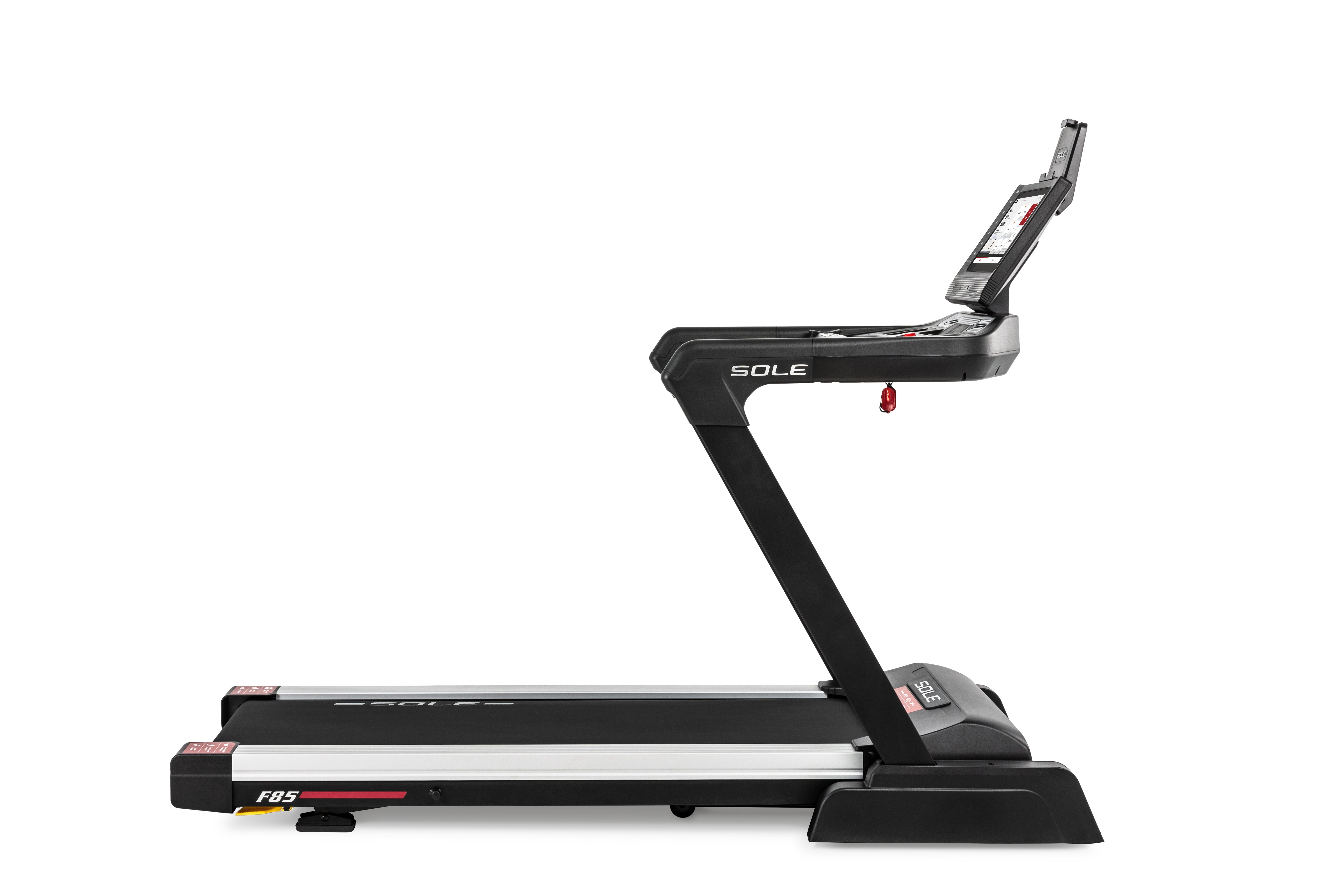 Side view of the Sole F85 treadmill displaying its sleek black frame, the "SOLE" branding on the side arm, and the "F85" logo on the gray deck with red accents. The treadmill's digital display screen is perched at the top, and the running belt surface is clearly visible.