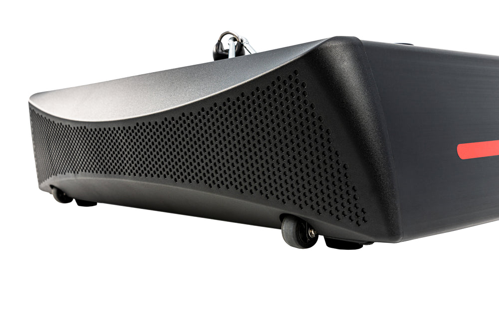 Close-up view of the Sole SRVO's side, showcasing its textured black surface, red accent, and caster wheels.
