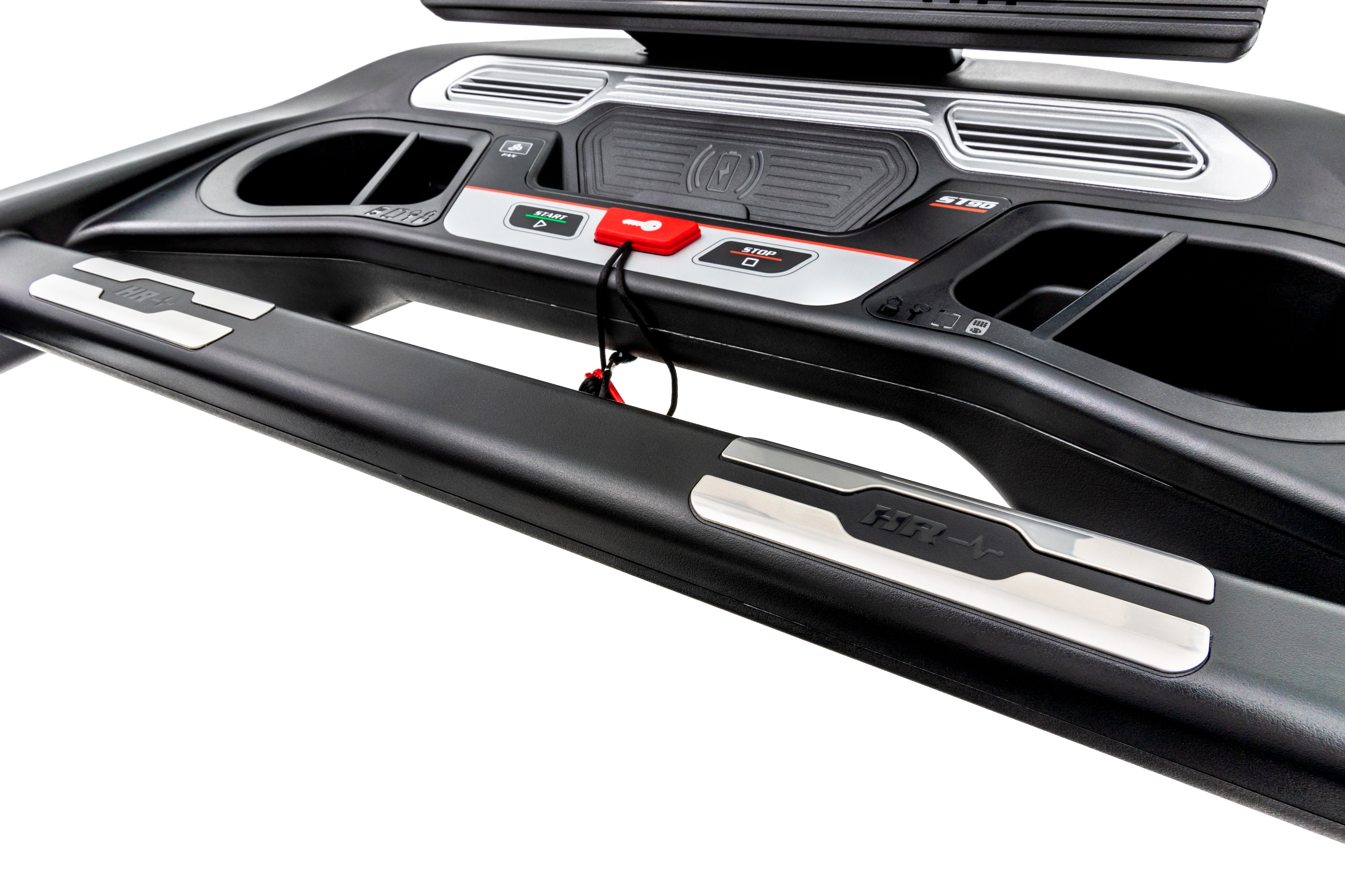 Detailed view of the Sole ST90 treadmill's control panel, displaying the digital screen, various buttons including emergency stop, and built-in cup holders on a sleek black design.